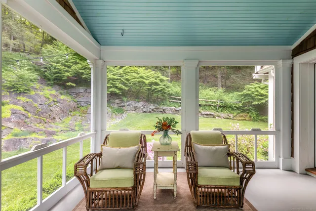 a balcony with furniture and a potted plant