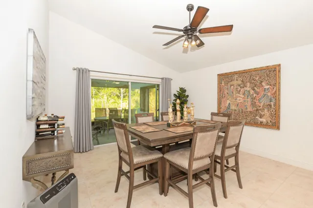 a view of a dining room with furniture and a window