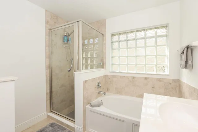 a bathroom with a bathtub and a shower