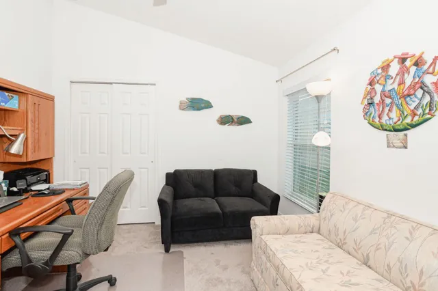 a living room with furniture a rug and a window