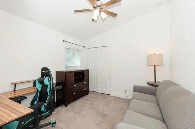 a living room with furniture and a lamp