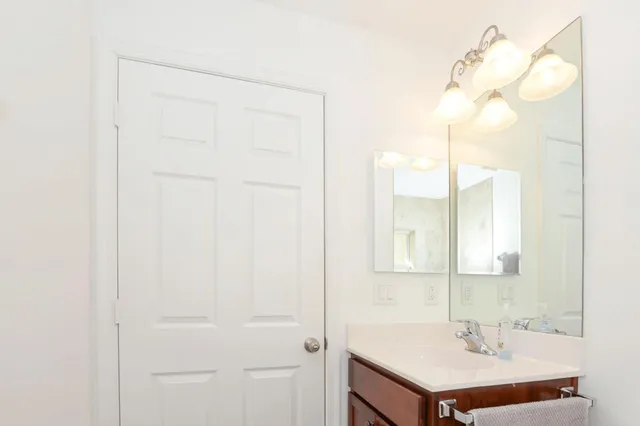 a bathroom with a sink a mirror and a shower