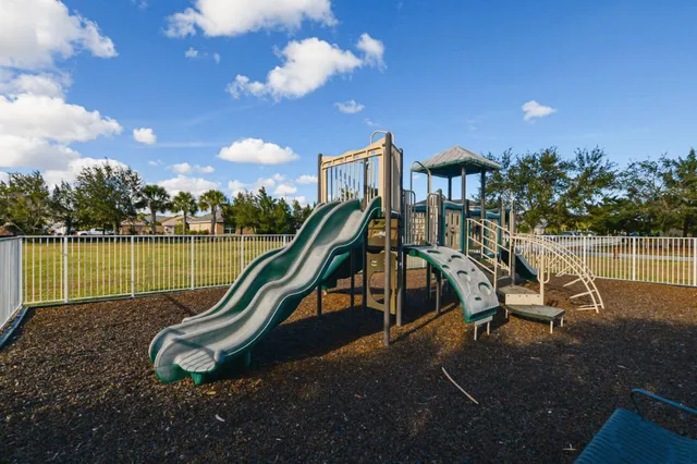 a living room with furniture chandelier and a flat screen tv