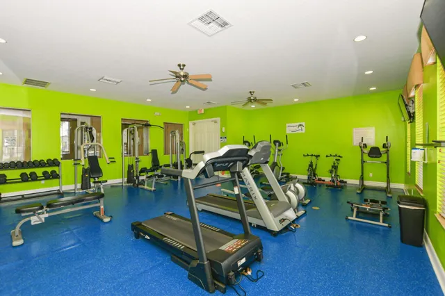 a view of a swimming pool with a yard and plants