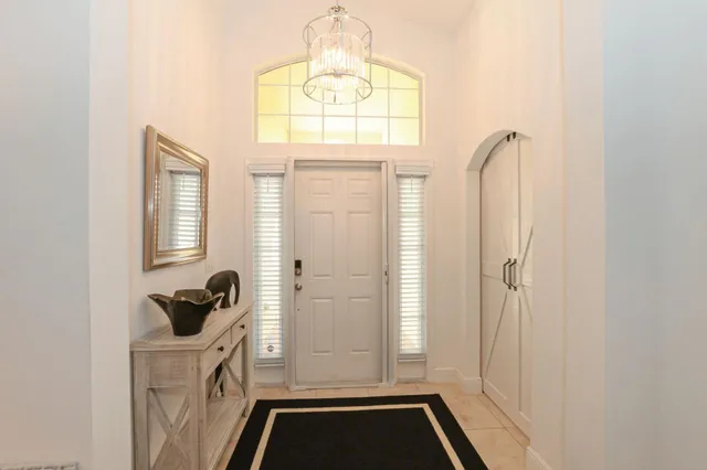 a bathroom with a sink a mirror a window and a shower
