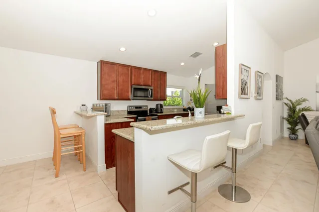 a kitchen with a sink cabinets and window