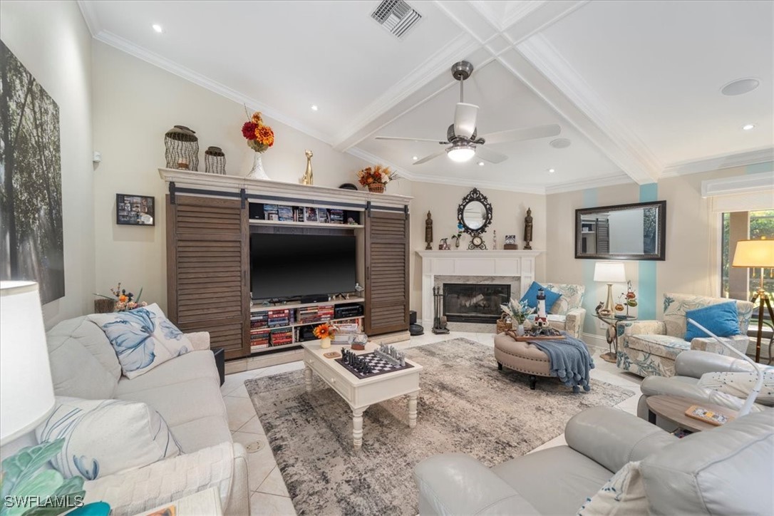 19 Winewood Court Fort Myers, FL 33919 - Photo 7 of 42 a living room with furniture a fireplace and a flat screen tv