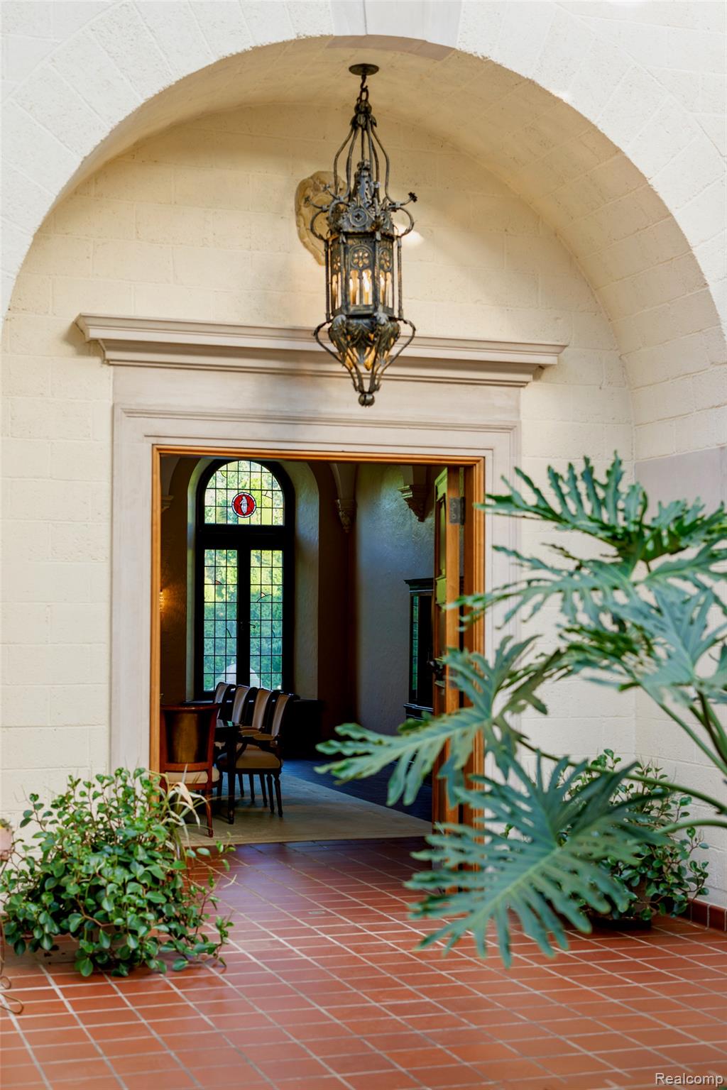 189 Cloverly Road Grosse Pointe, MI 48236 - Photo 9 of 93 Graceful masonry arches frame the entrance to the formal dining room, where massive original wood doors welcome guests for memorable gatherings.