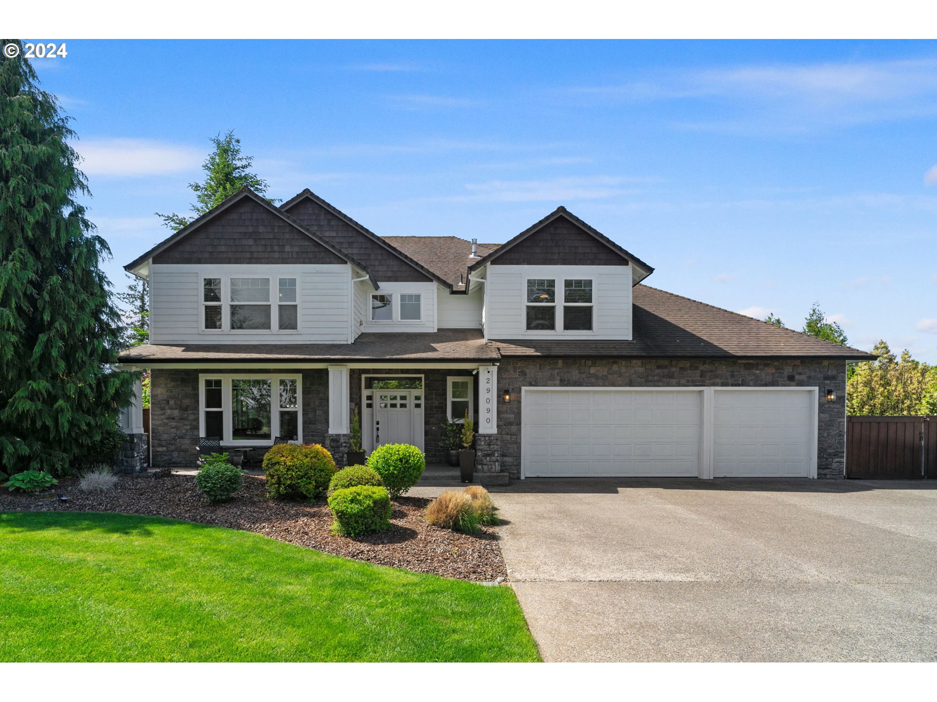 29090 Southeast Powell Valley Road Gresham, OR 97080 - Photo 2 of 45 a front view of a house with a yard and potted plants