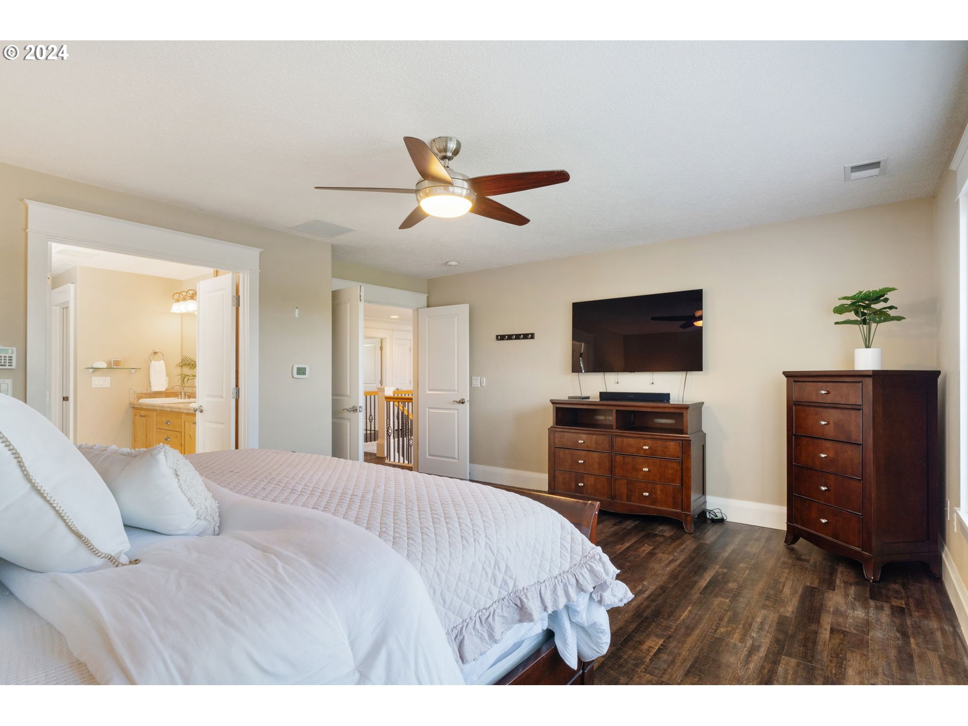 29090 Southeast Powell Valley Road Gresham, OR 97080 - Photo 23 of 45 a bedroom with a bed and a flat screen tv