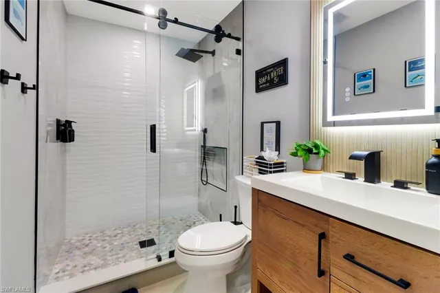 a bathroom with a sink toilet and shower