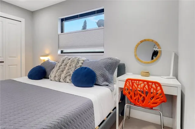 a bedroom with a bed and lamp