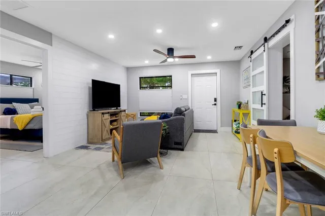 a living room with furniture and kitchen view