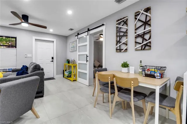 a view of kitchen with stainless steel appliances refrigerator stove dining table and chairs