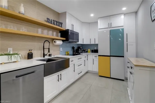 a kitchen with stainless steel appliances a sink a stove and cabinets