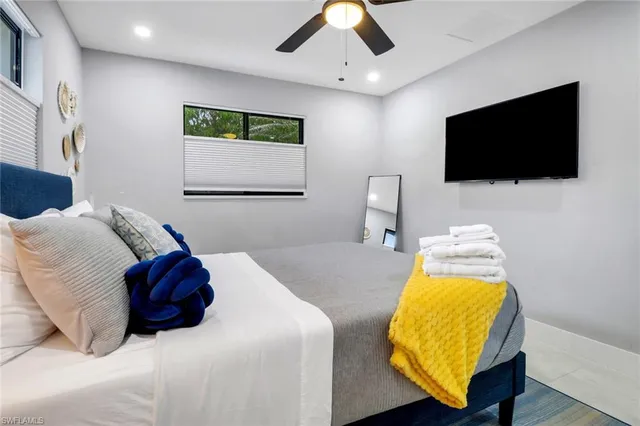 a bedroom with a bed and a flat screen tv