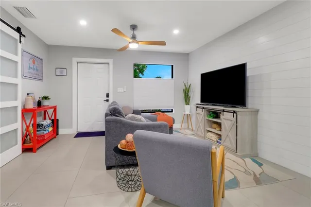 a living room with furniture and a flat screen tv