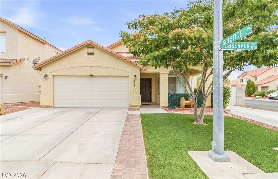 9523 Observer Street Las Vegas, NV 89123 - Photo 1 of 42 A well-maintained facade with a tiled roof and inviting porch entry, complemented by artificial turf.