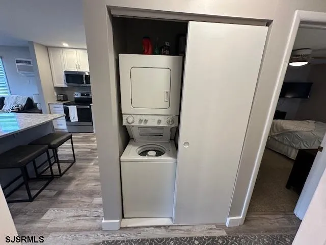 a view of a storage and utility room with washer and dryer