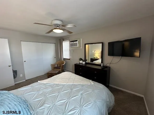 a bedroom with a bed tv and a chandelier