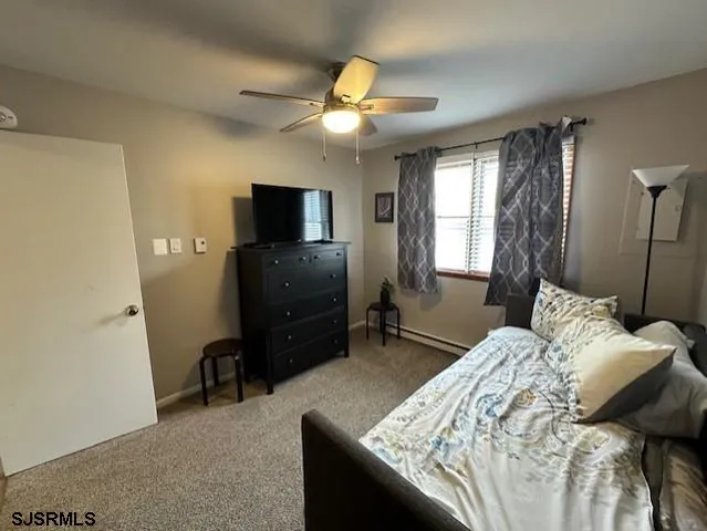 a bedroom with a bed and a television