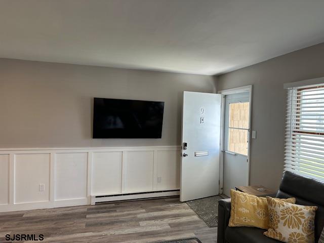 251 4th Street South, Unit 9 Brigantine, NJ 08203 - Photo 4 of 19 a living room with furniture and a flat screen tv