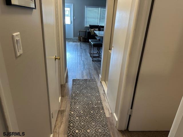 251 4th Street South, Unit 9 Brigantine, NJ 08203 - Photo 10 of 19 a view of a hallway view with wooden floor and staircase