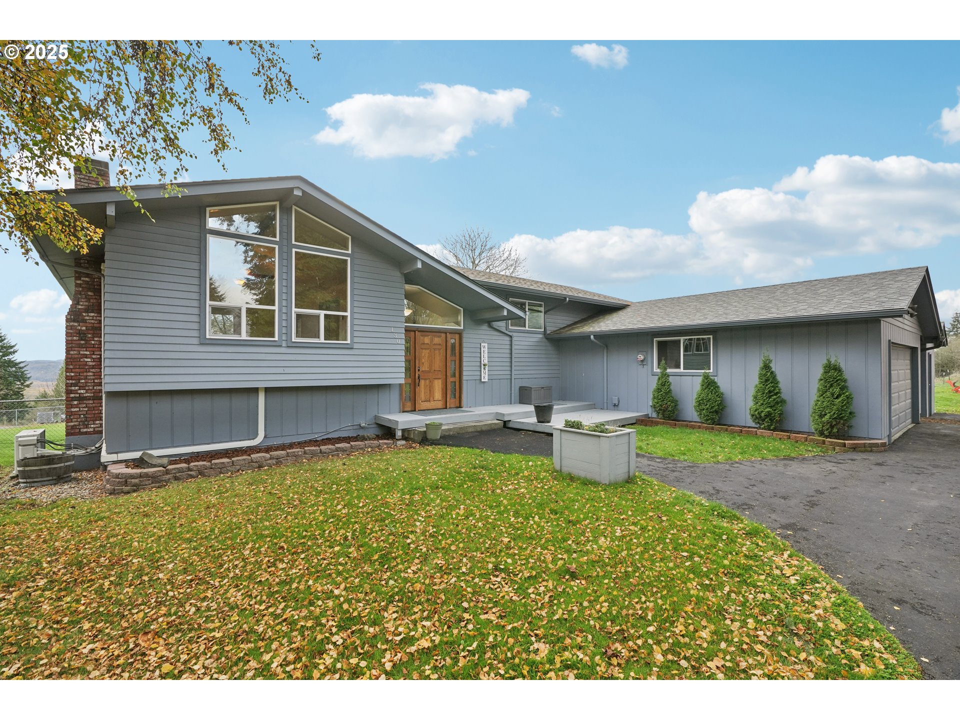 a view of a house with backyard and sitting area