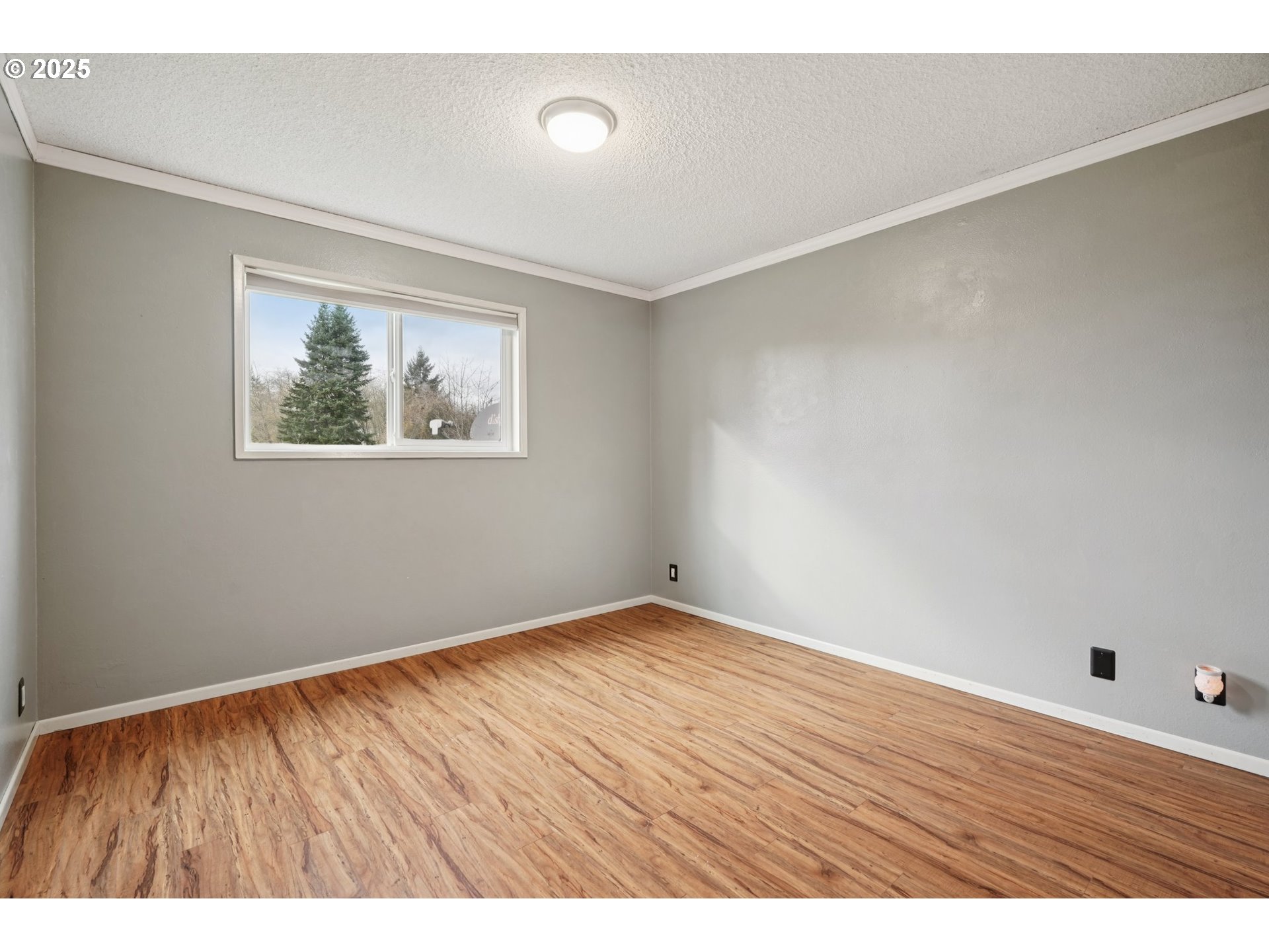 130 Stella Lane Longview, WA 98632 - Photo 22 of 41 an empty room with wooden floor and windows