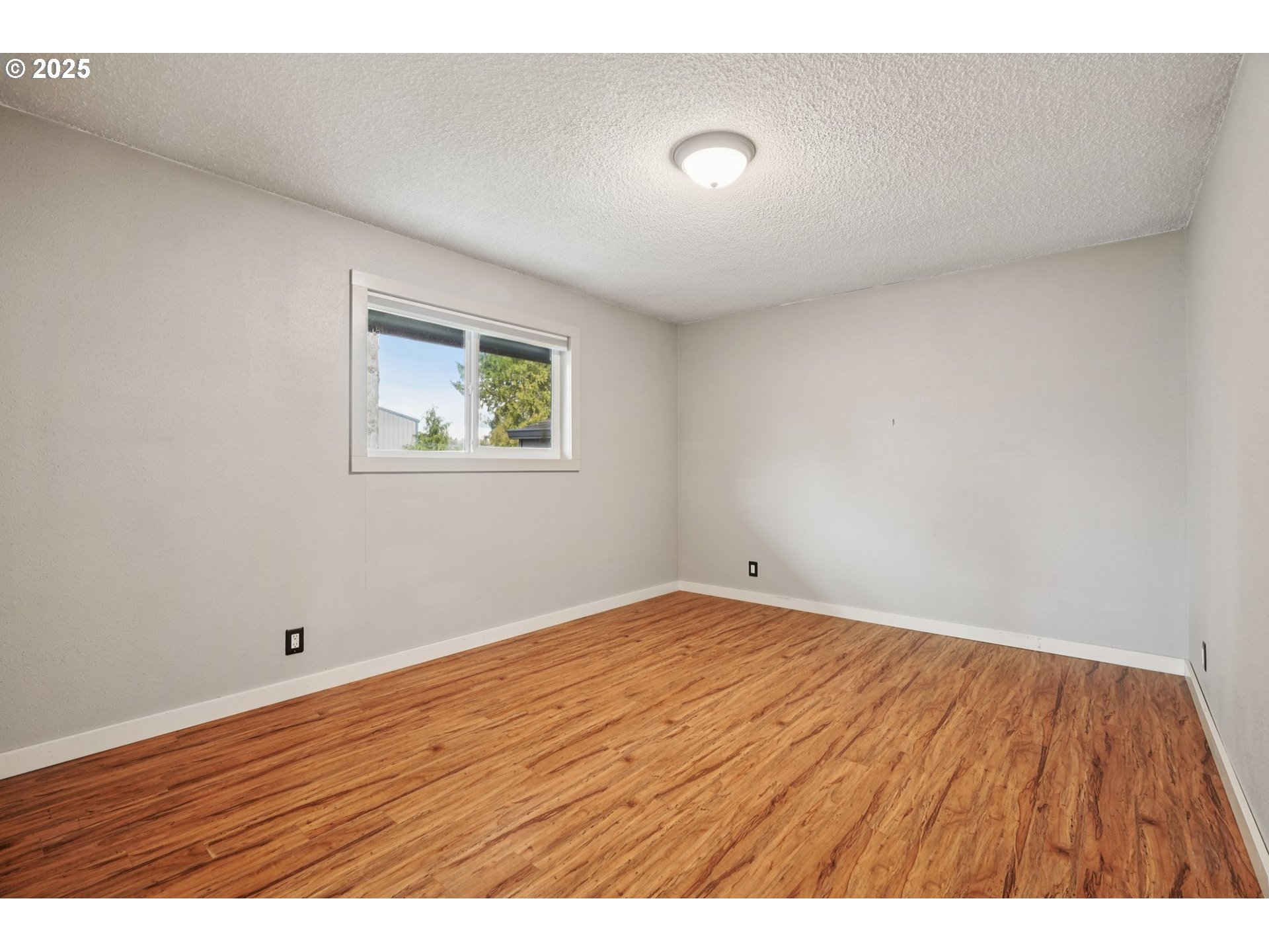 130 Stella Lane Longview, WA 98632 - Photo 24 of 41 a view of an empty room with wooden floor and a window
