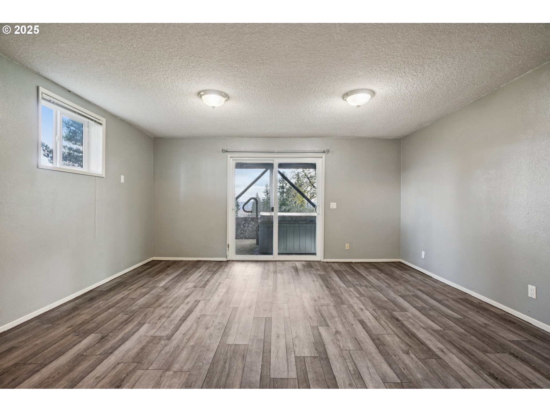130 Stella Lane Longview, WA 98632 - Photo 28 of 41 an empty room with wooden floor and windows