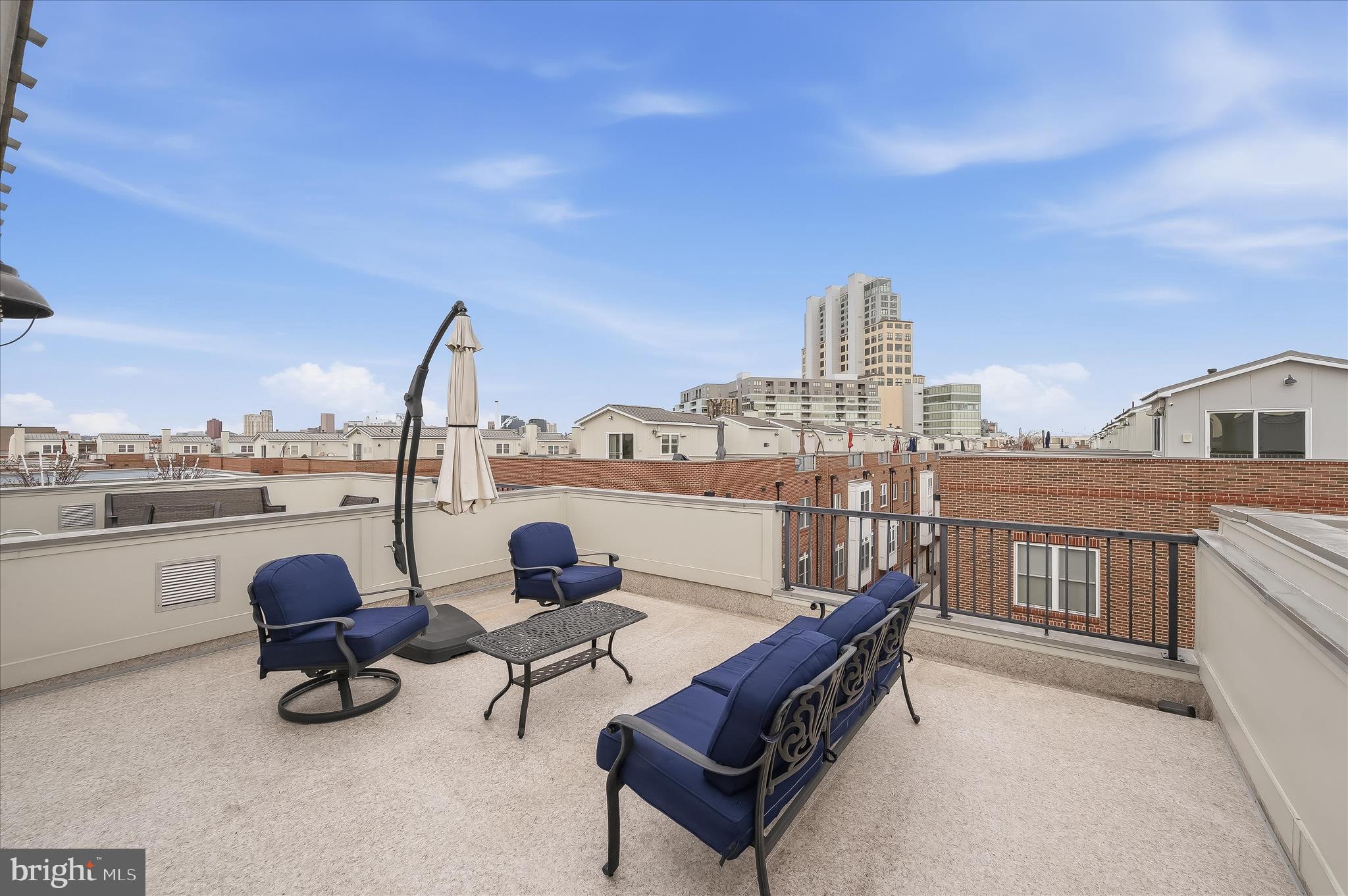 1906 East Fort Avenue Baltimore, MD 21230 - Photo 6 of 7 a roof deck with table and chairs