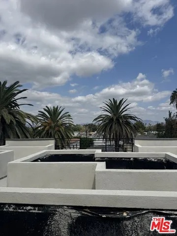 a view of kitchen island with furniture and refrigerator