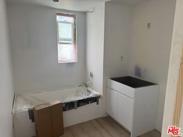 a kitchen with stainless steel appliances a refrigerator and a stove top oven