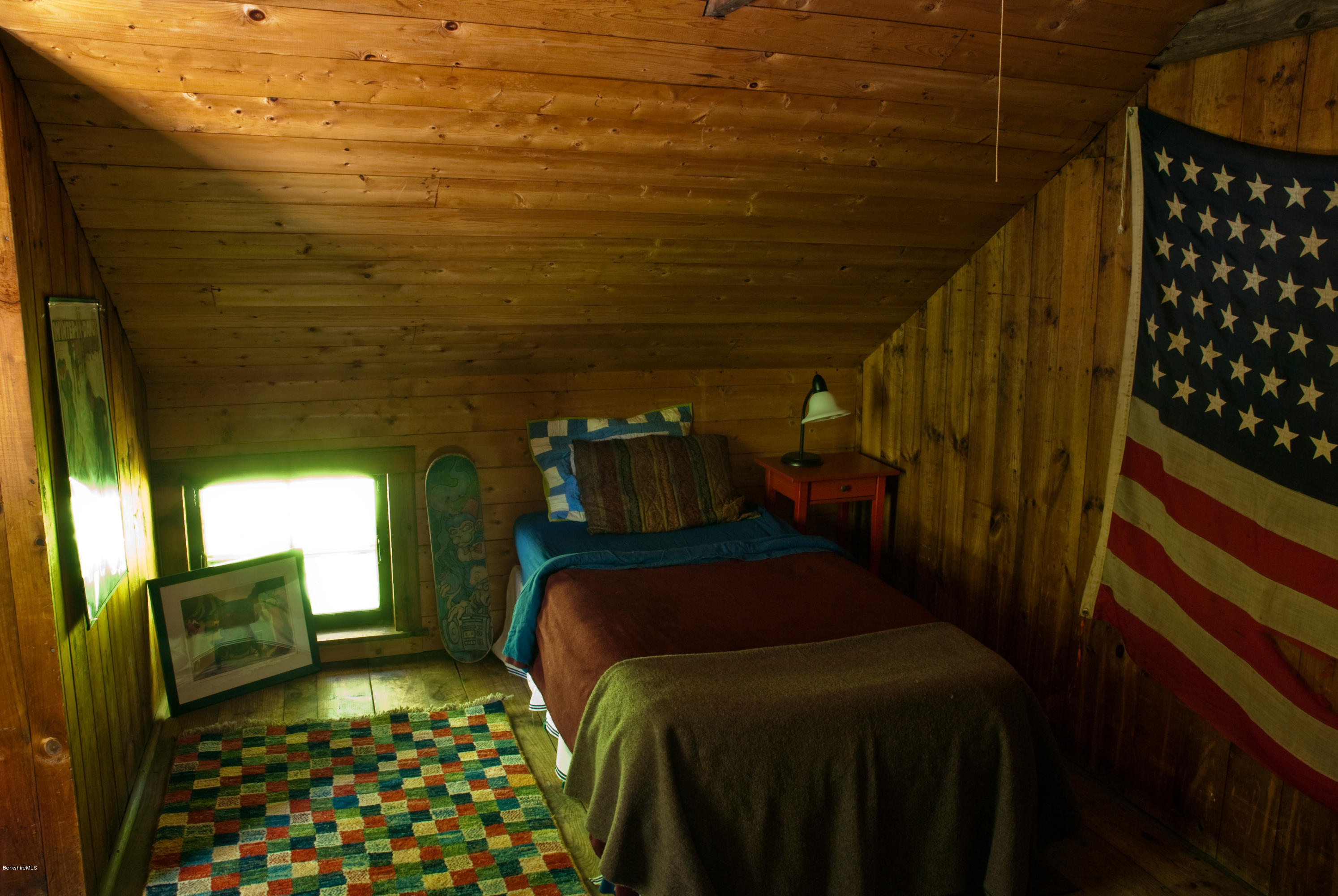 22 Bidwell Road Monterey, MA 01245 - Photo 29 of 46 a bedroom with a bed and wooden floor