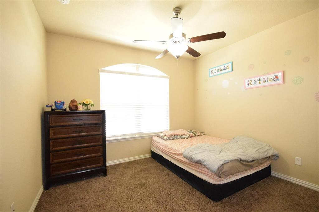 12421 Hitch Rack Way McKinney, TX 75071 - Photo 12 of 21 a bedroom with a bed and a chandelier