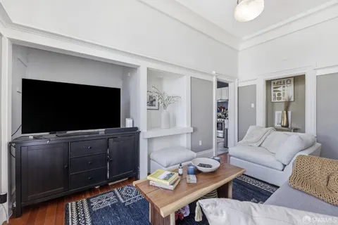 a kitchen with stainless steel appliances granite countertop a stove a refrigerator a dining table and chairs