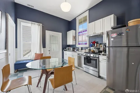 a kitchen with stainless steel appliances granite countertop a refrigerator and a stove top oven