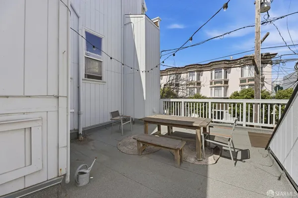 a view of a patio with a table and chairs