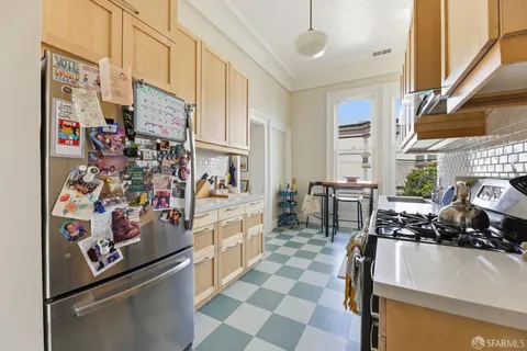 a kitchen with a sink stove and cabinets
