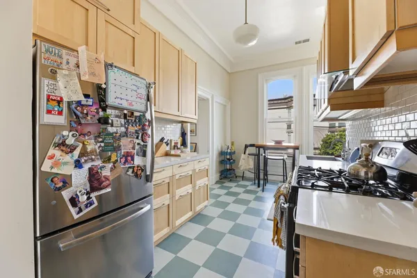 a kitchen with a sink stove and cabinets