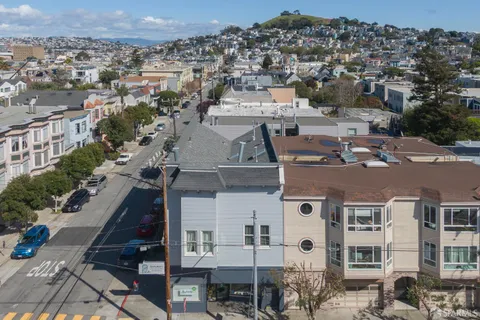 an aerial view of a residential apartment building with a yard