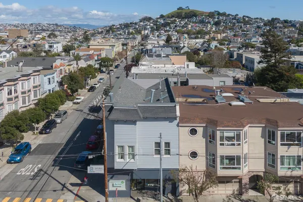 an aerial view of a residential apartment building with a yard