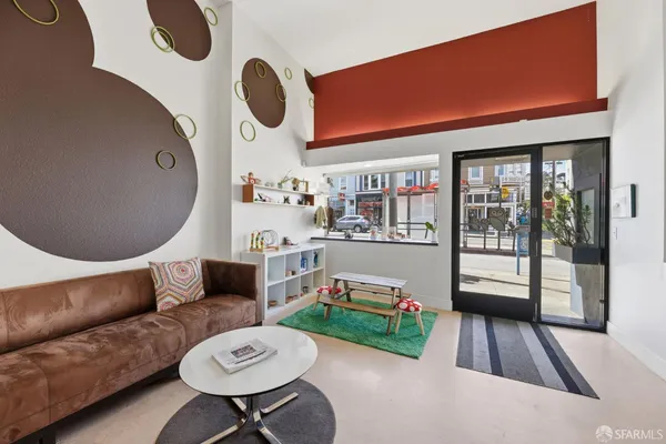 a living room with furniture and a mirror