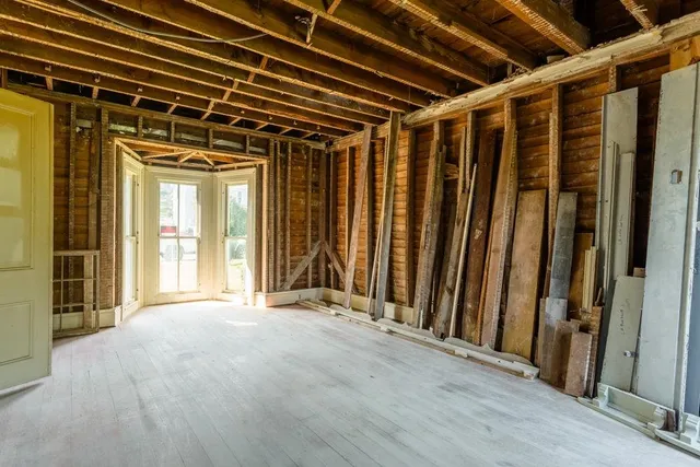 a view of a room with wooden floor and windows
