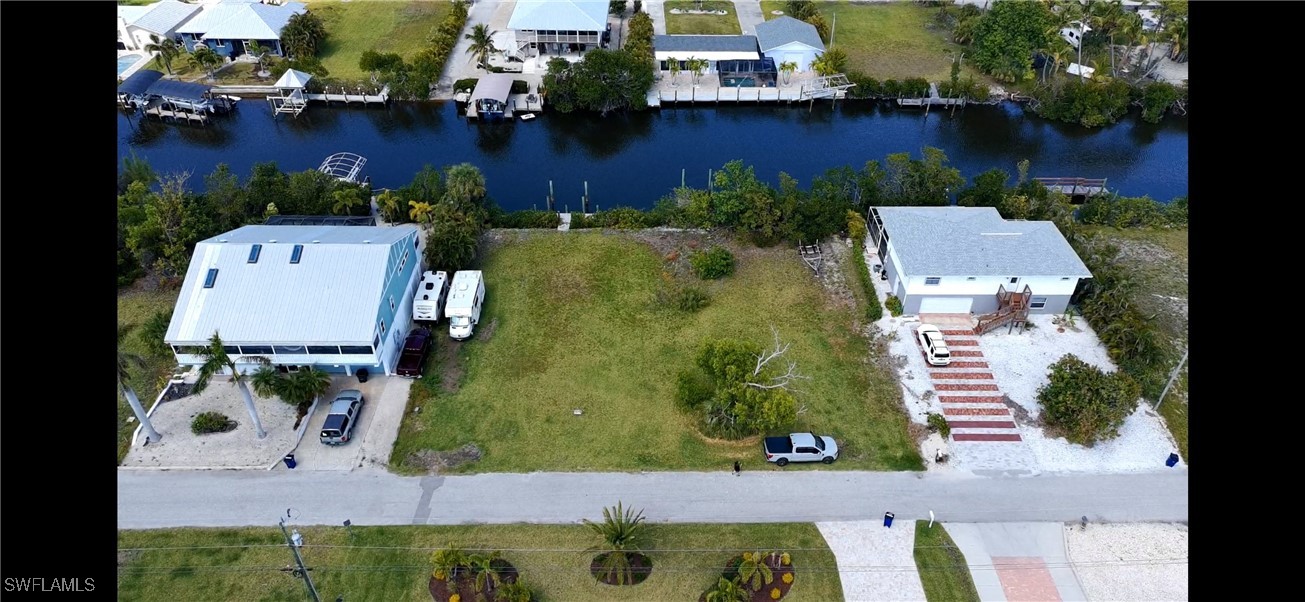 5250 Martin Cove Bokeelia, FL 33922 - Photo 1 of 7 an aerial view of residential houses with outdoor space and parking
