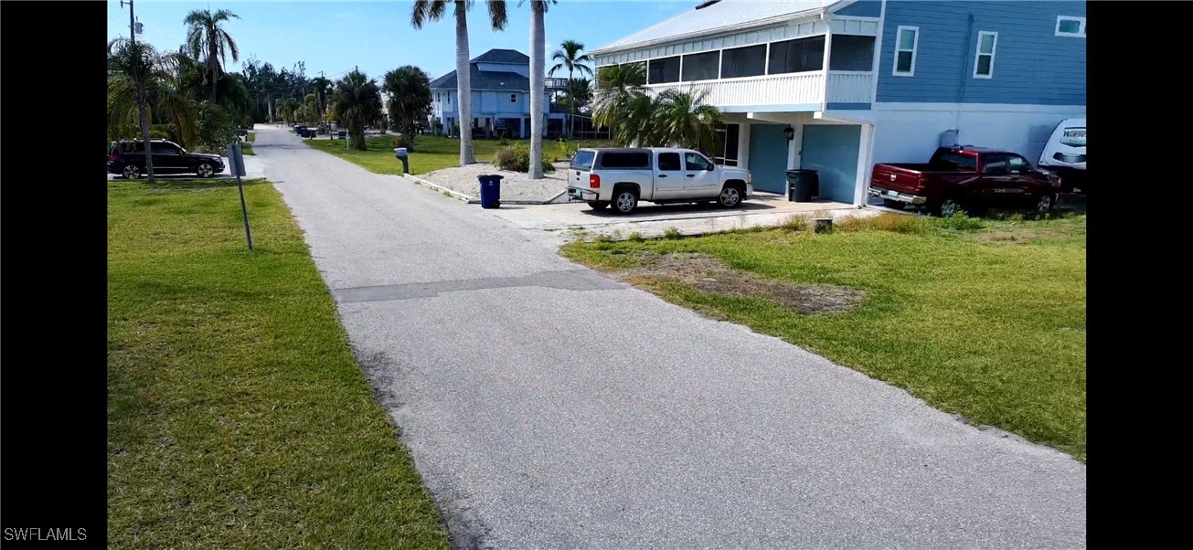 5250 Martin Cove Bokeelia, FL 33922 - Photo 7 of 7 a view of outdoor space with garden and car parked