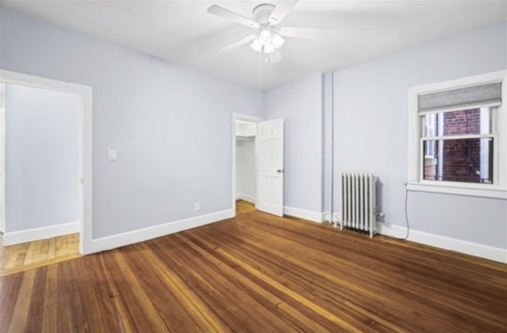1834 Beacon Street, Unit 5 Brookline, MA 02445 - Photo 4 of 6 a view of empty room with wooden floor and fan