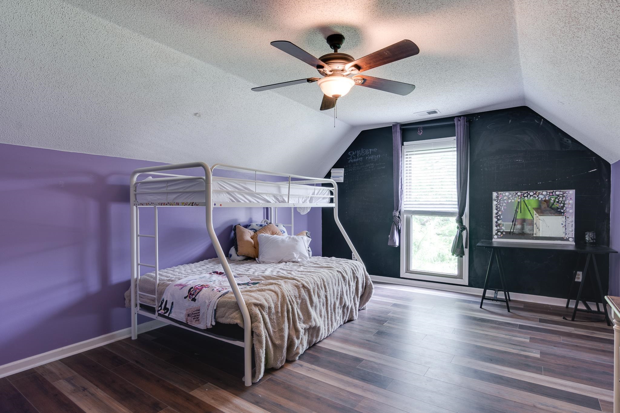 779 Early Earner Cove Collierville, TN 38017 - Photo 21 of 29 Room featuring wood-finish flooring, a sloped ceiling, and a ceiling fan with integrated lighting
