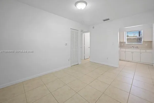 a view of kitchen with granite countertop cabinets